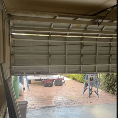 ectional residential paneling fixed halfway up the tracks during an emergency garage door repair Odessa TX service callout.