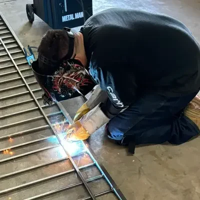 Custom metal welding and structural frame reinforcement performed by a local technician for residential garage door repair in Odessa, TX.
